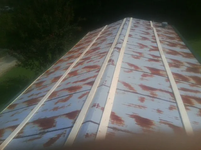 Rusted metal roof panels with new wood purlins before replacement — Storm Damage Roof Repair in Terrell by Roofing Brothers